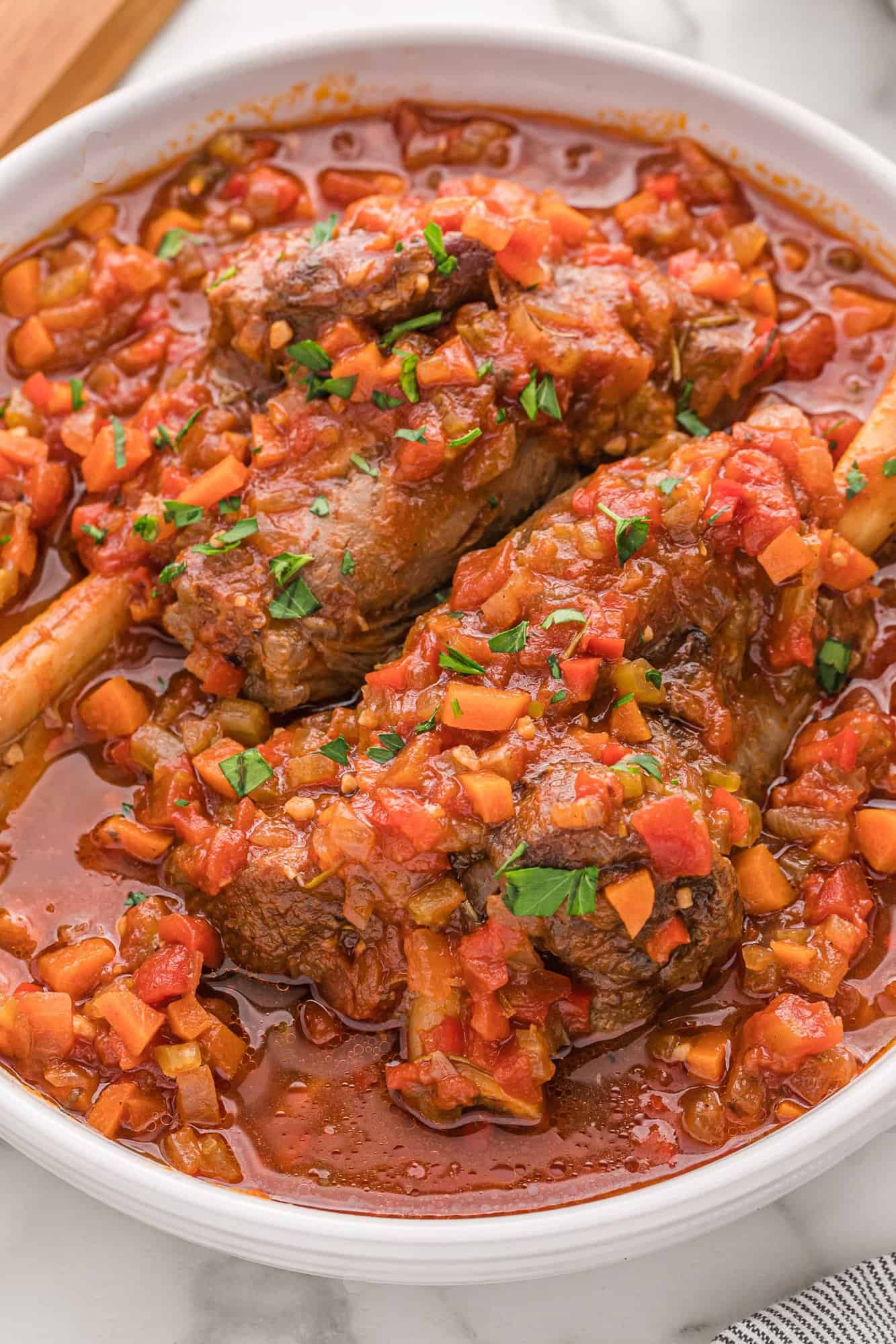 Lamb shanks in a braising liquid. 