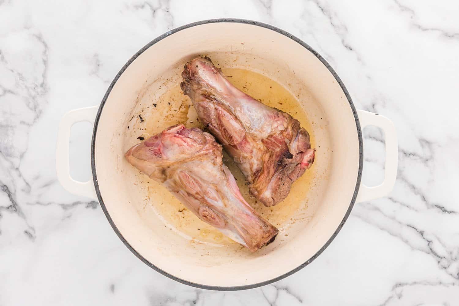 Lamb shanks being browned.