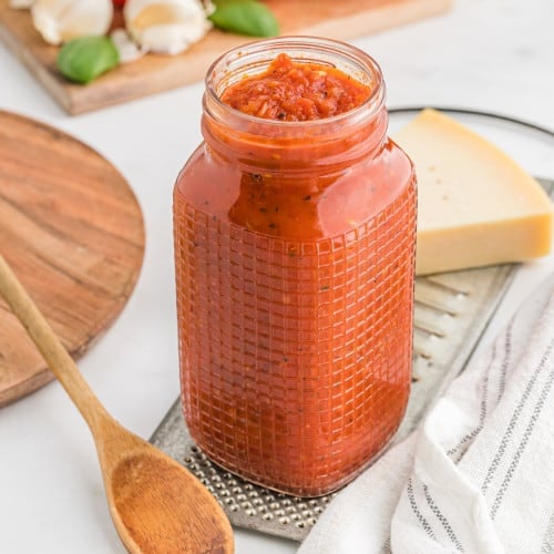 Homemade pizza sauce in a glass jar.