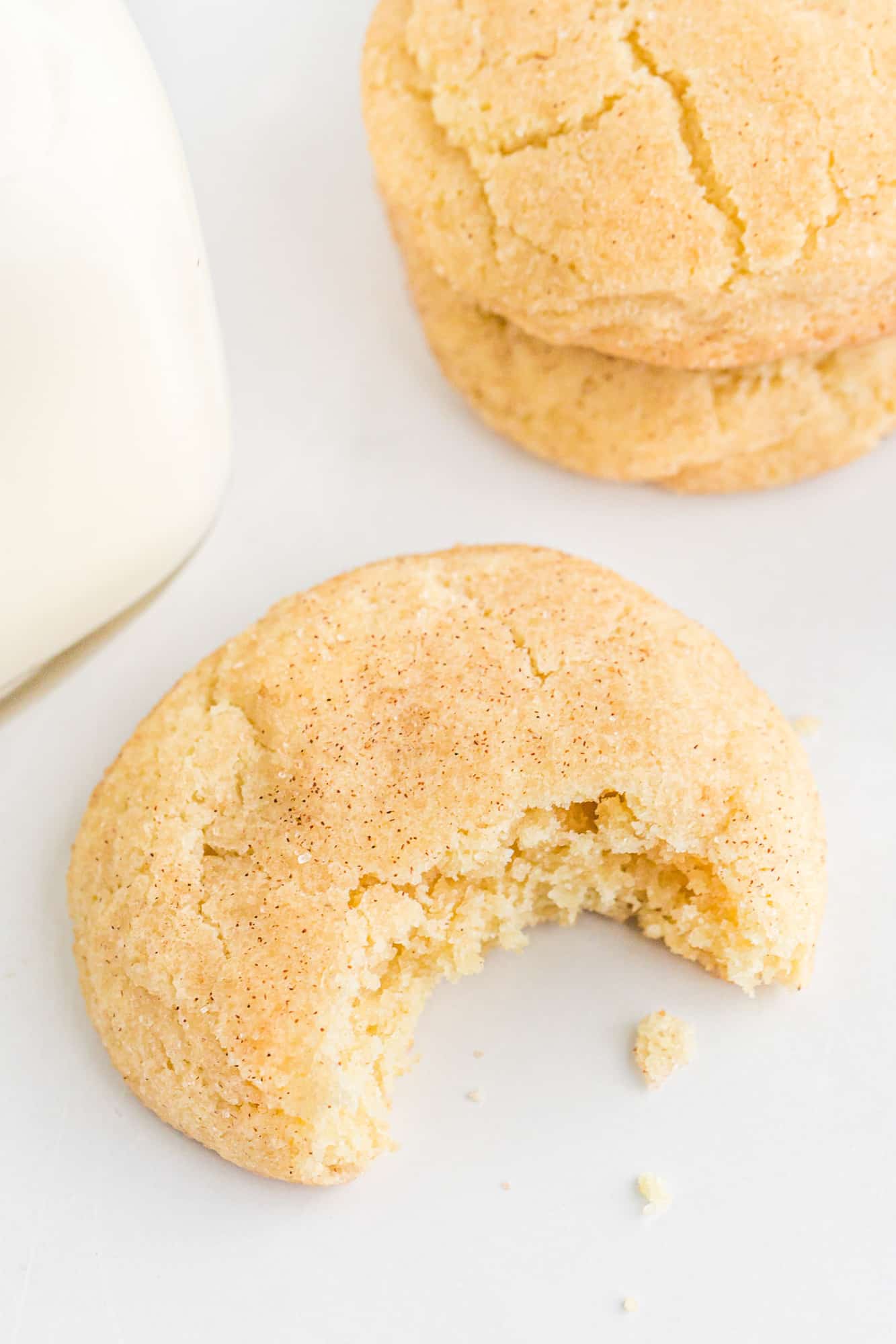 Snickerdoodle cookie with a large bite out of it.