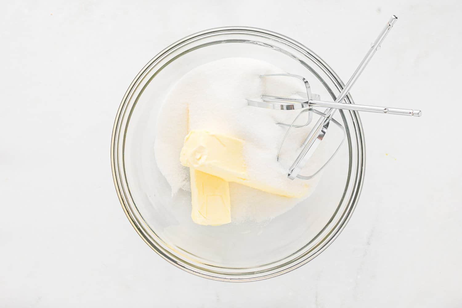 Butter and sugar in a mixing bowl.