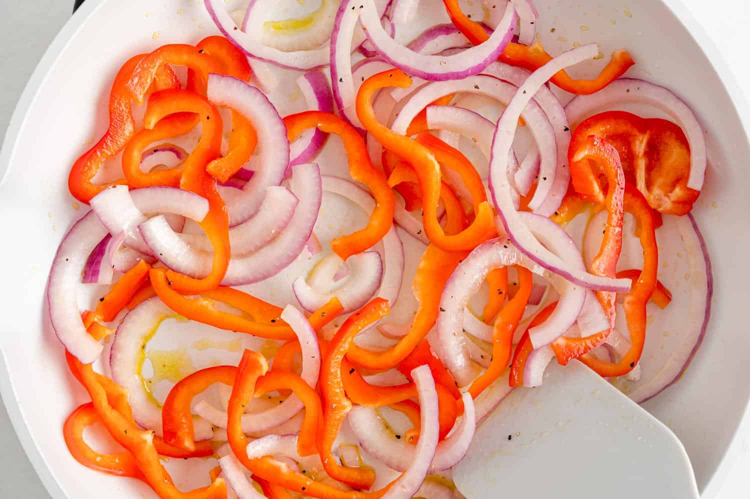 Onions and peppers being sautéed. 