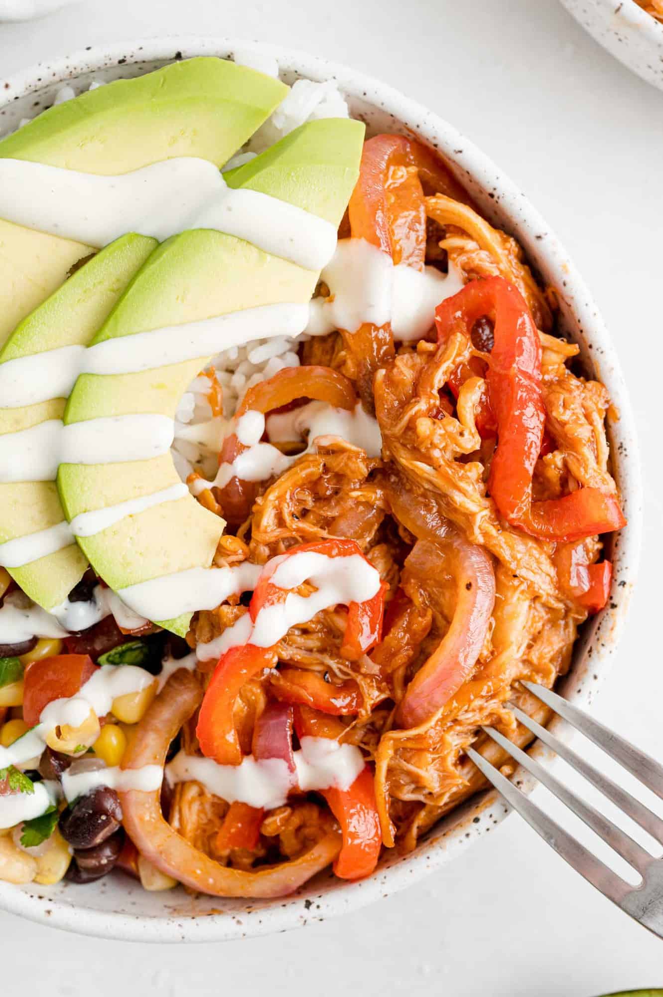 BBQ Chicken burrito bowl with avocado and sour cream.