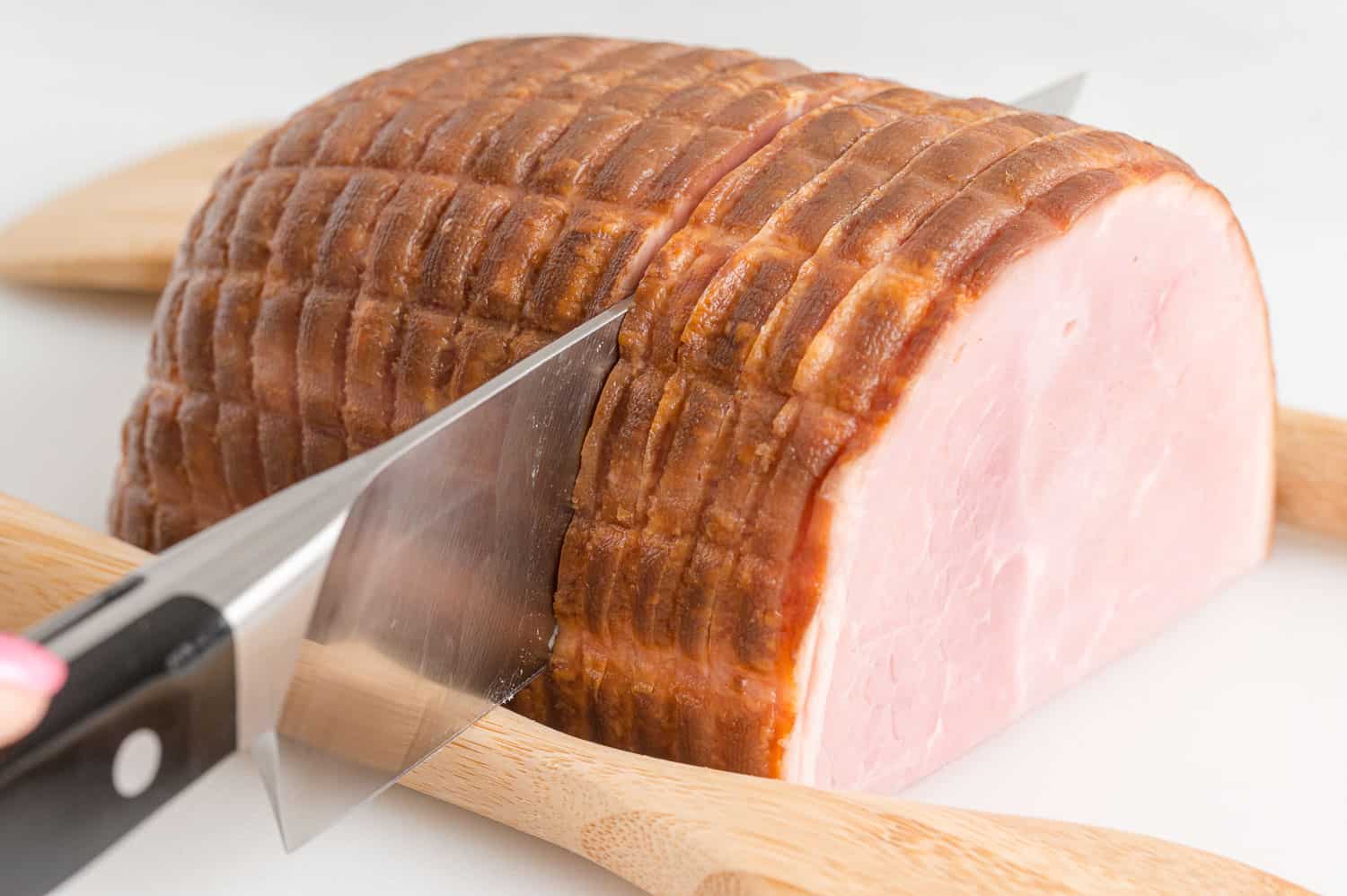 Another view of ham being sliced.