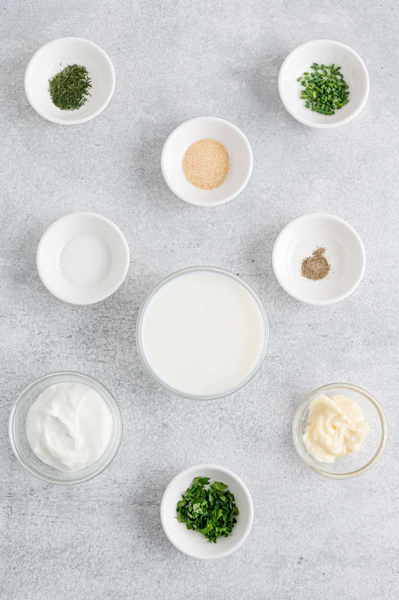 Ingredients needed in separate bowls, including fresh herbs.