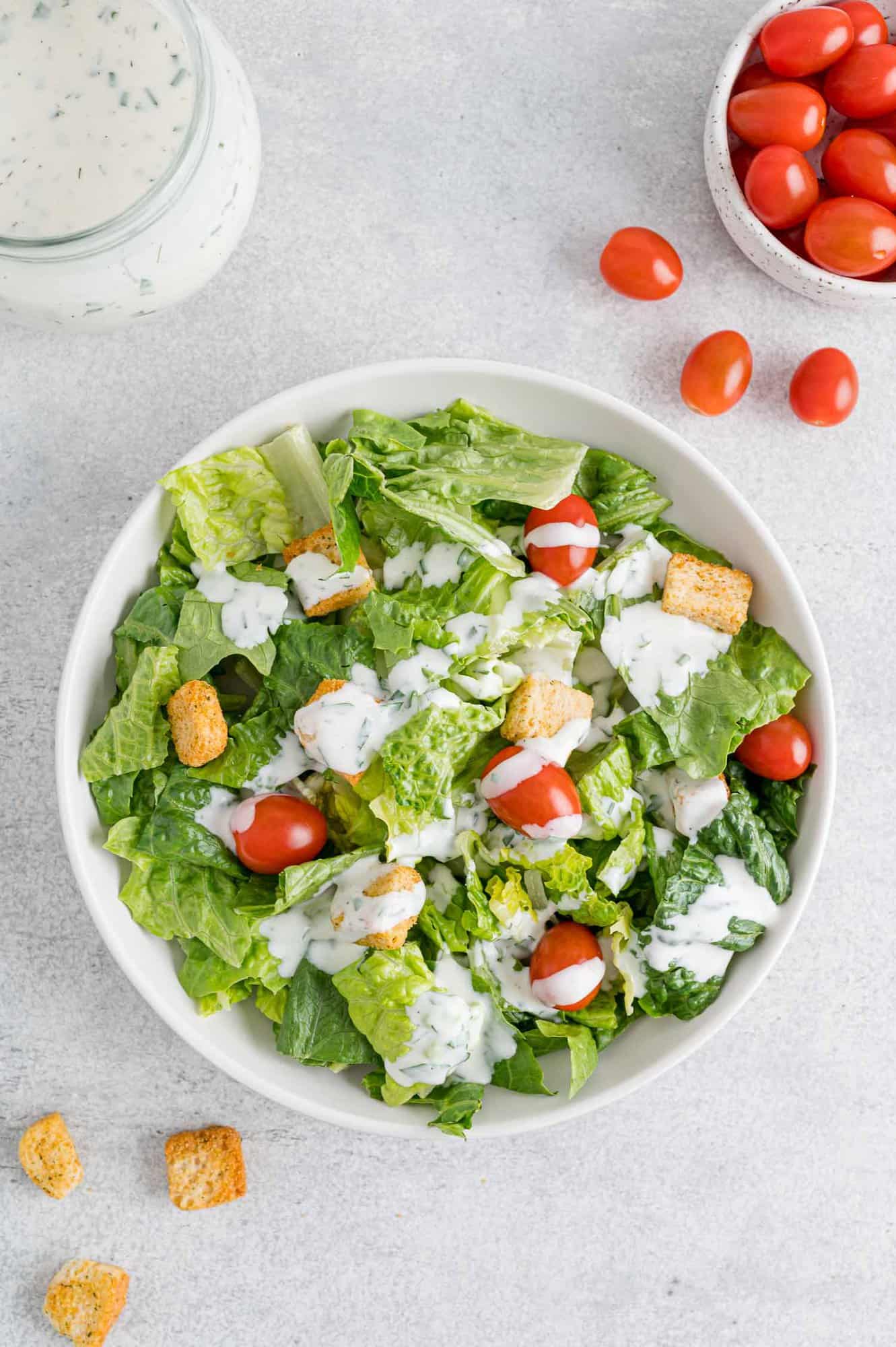 Dressing with romaine, tomatoes, croutons, and ranch dressing.