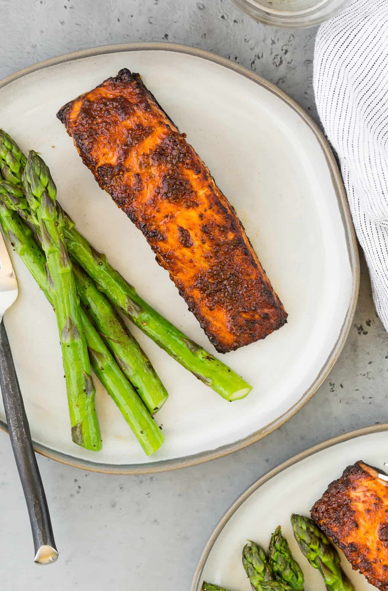 Air fryer salmon a plate with asparagus.