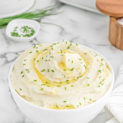 Creamy mashed potatoes topped with butter and chives.