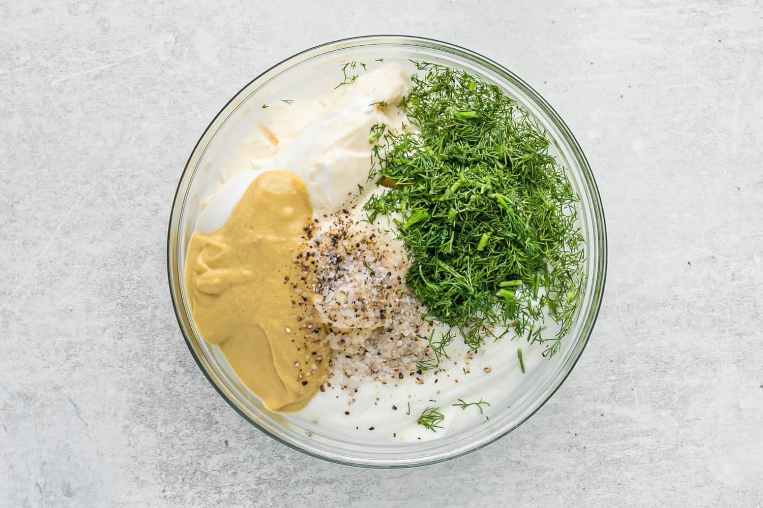 Dressing ingredients in a glass mixing bowl.