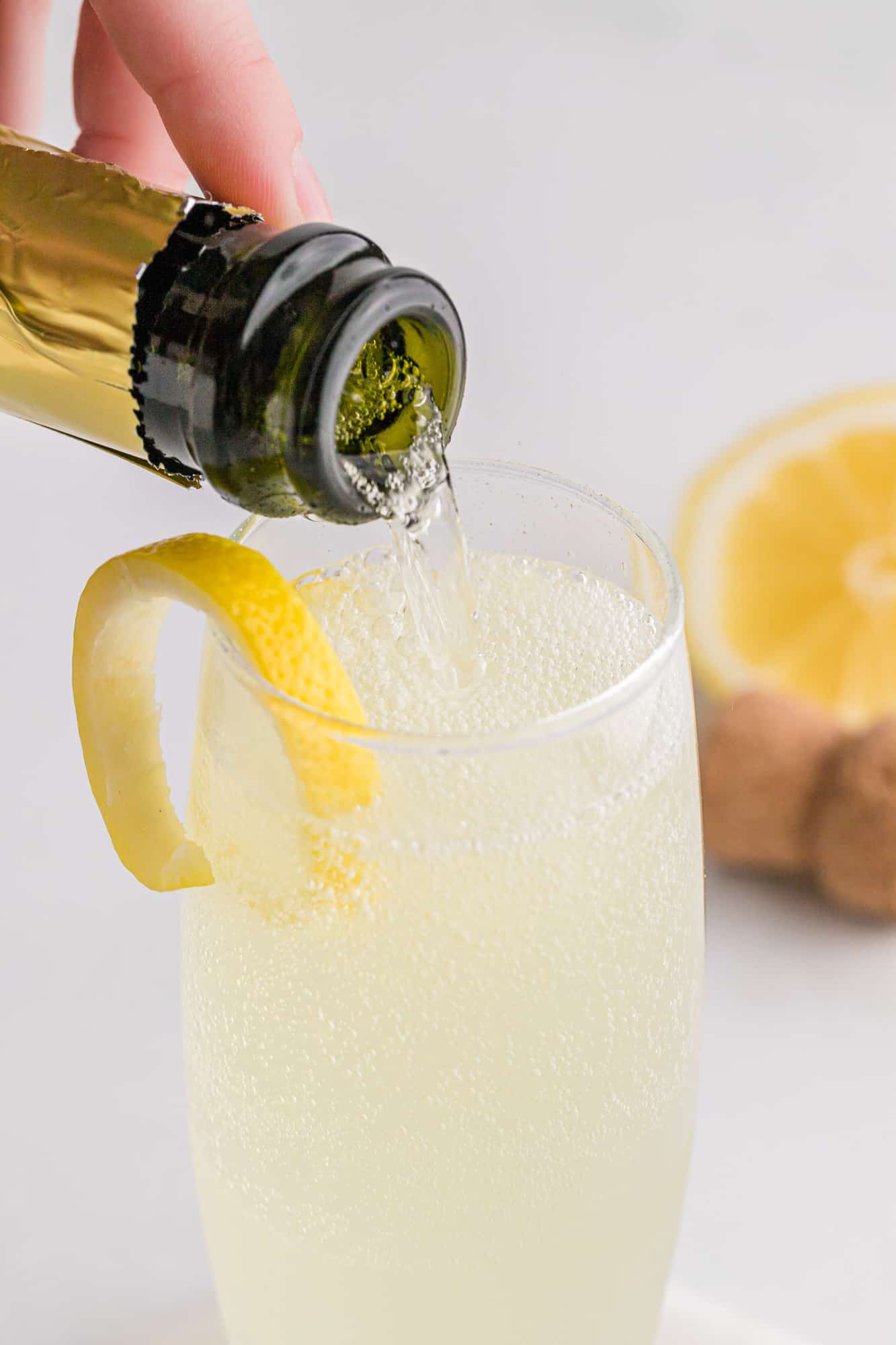 Prosecco being added to a french 75.