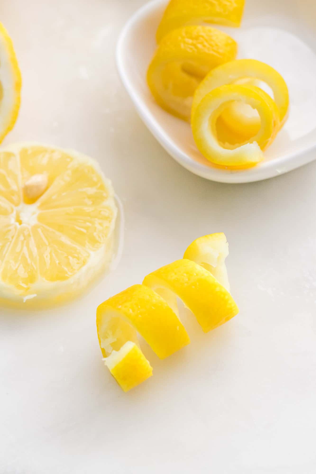 Lemon twist on a white surface.