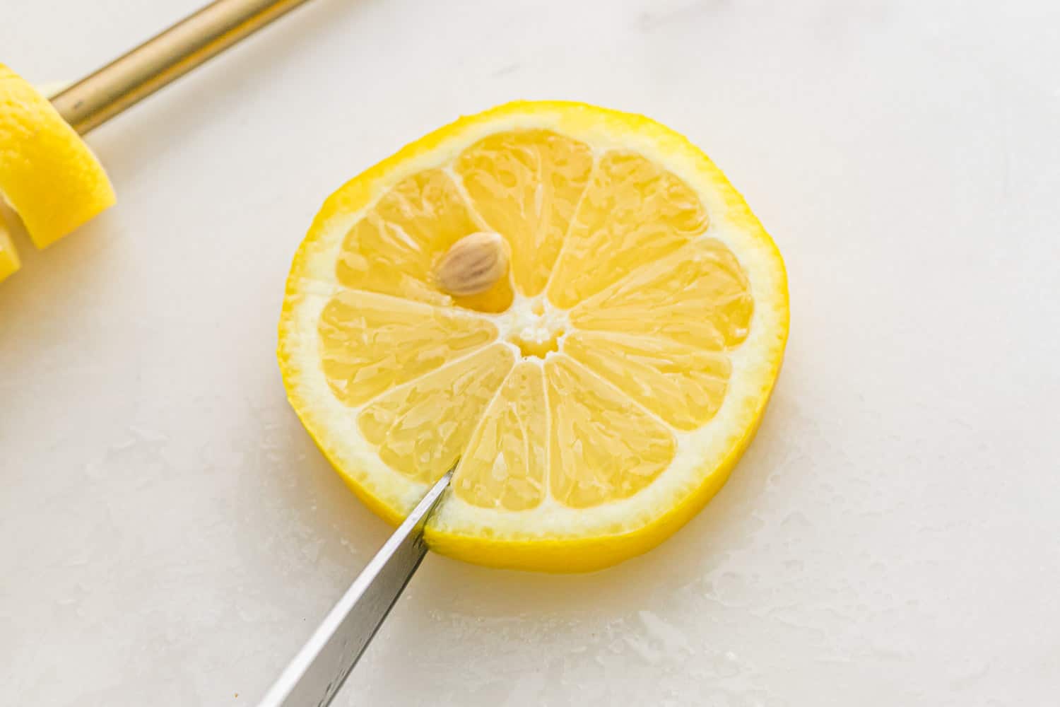 Slit being cut in a lemon wheel.