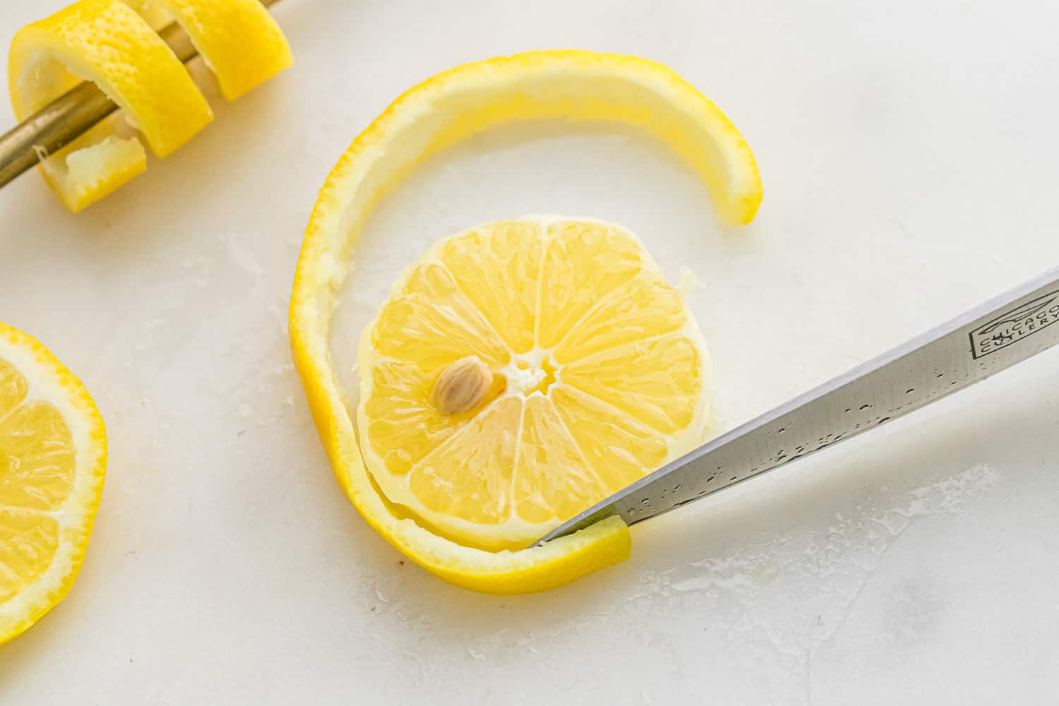 Peel being cut off a lemon wheel.