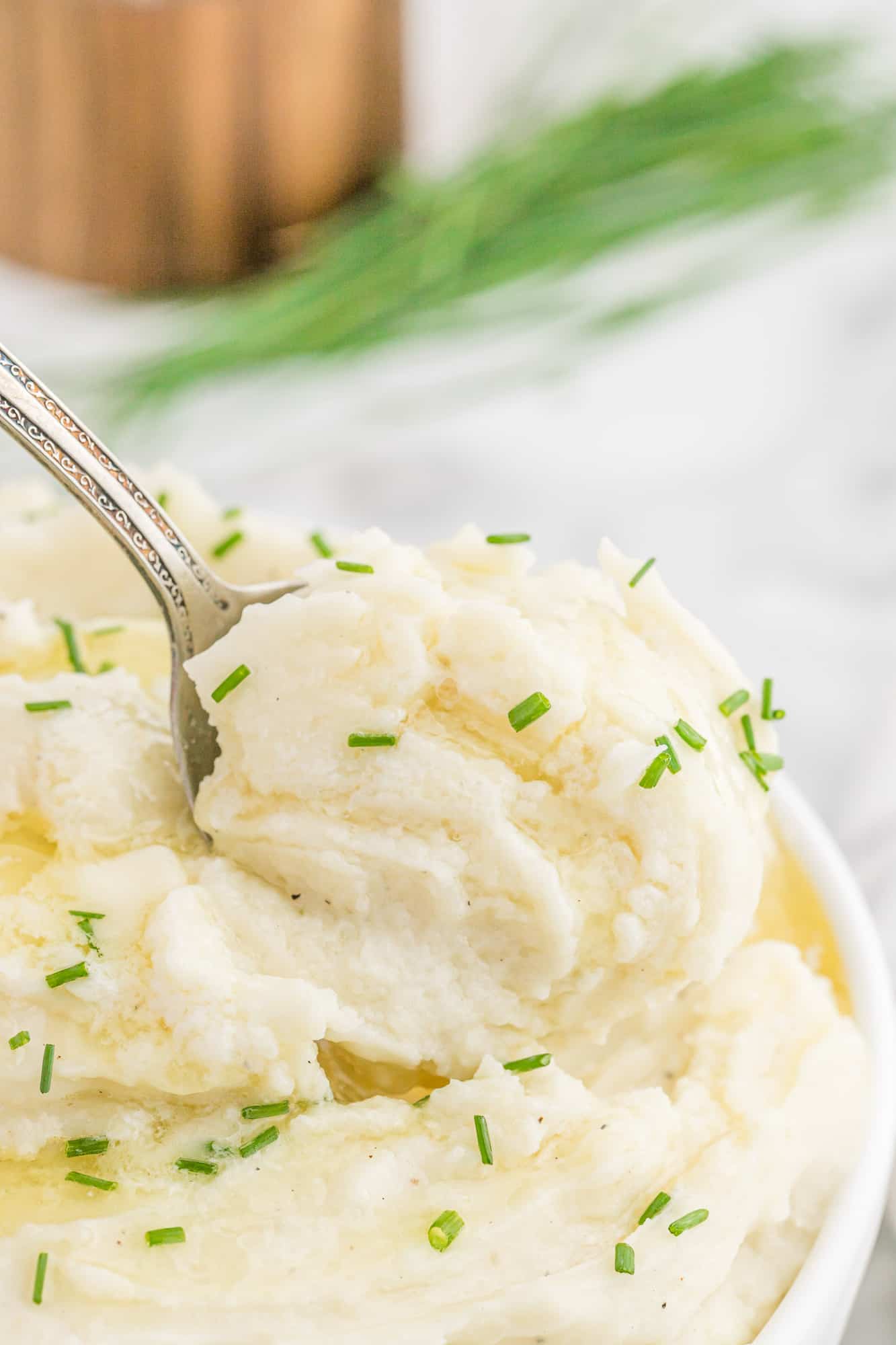 Creamy mashed potatoes on a serving spoon.