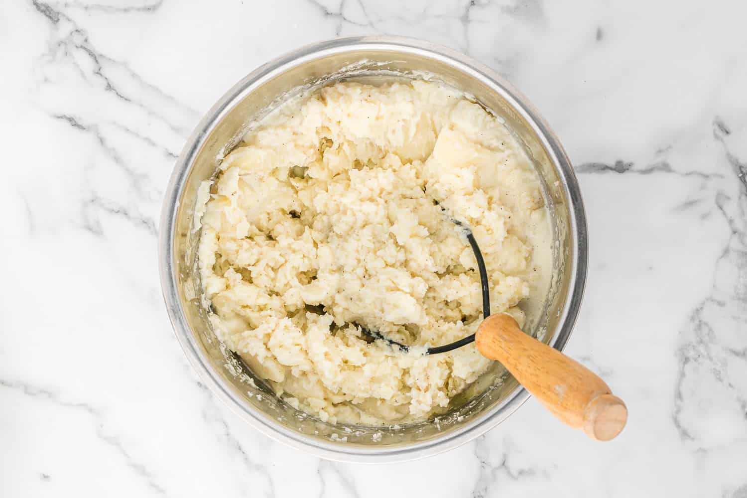 Potatoes mashed with a potato masher.