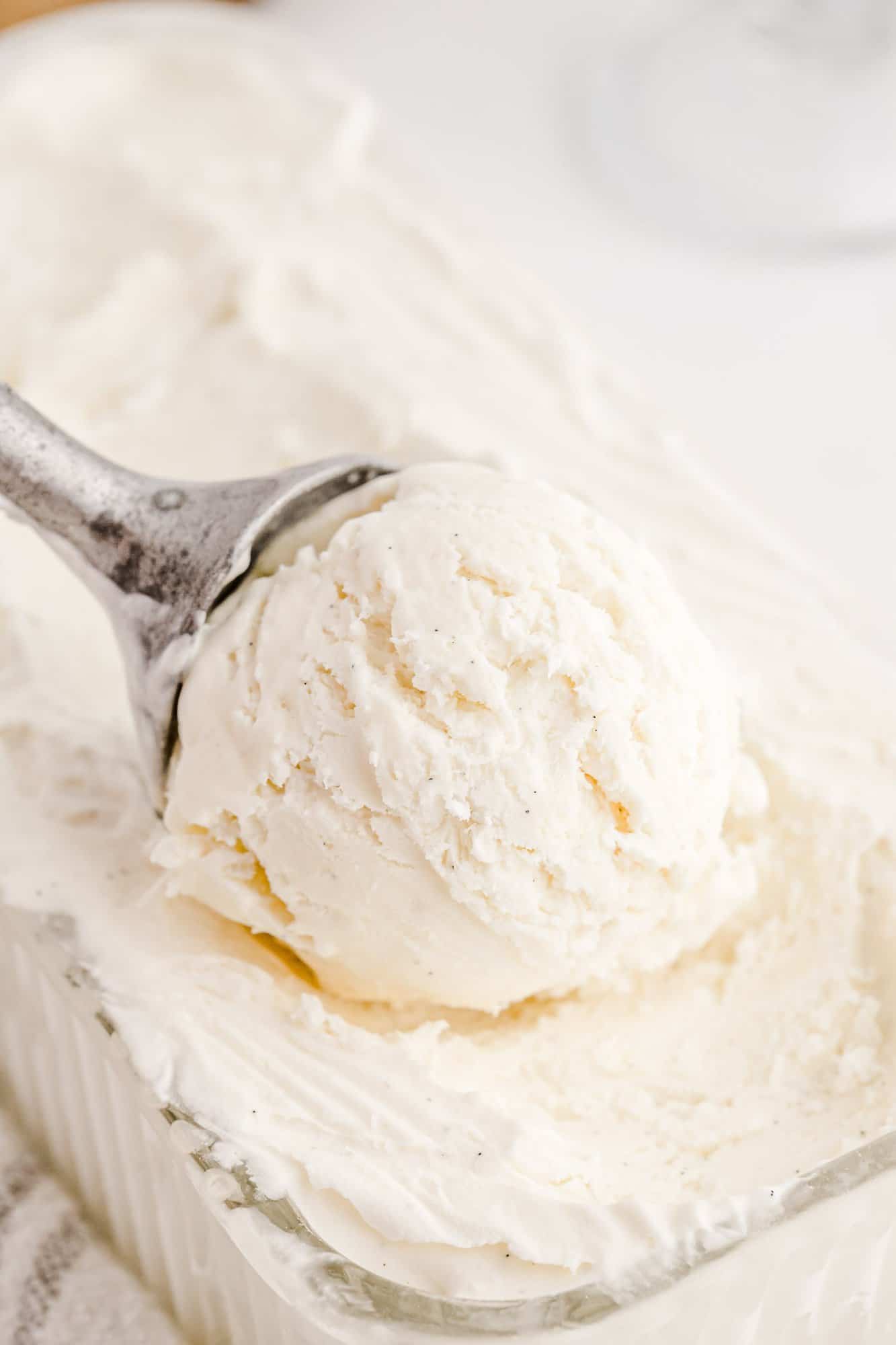 Ice cream being scooped out of loaf pan.