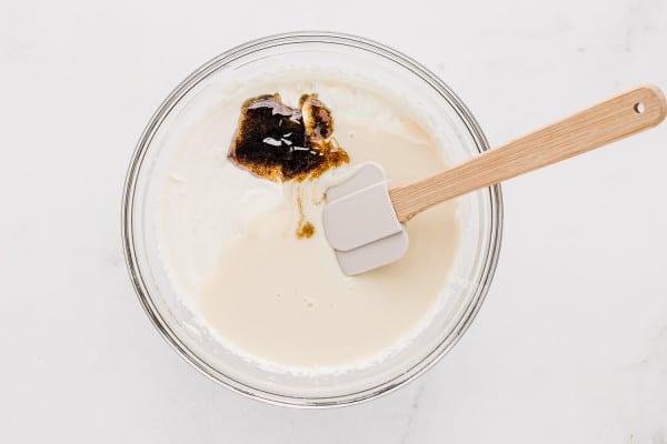 Vanilla bean paste is stirred into the vanilla ice cream mixture.