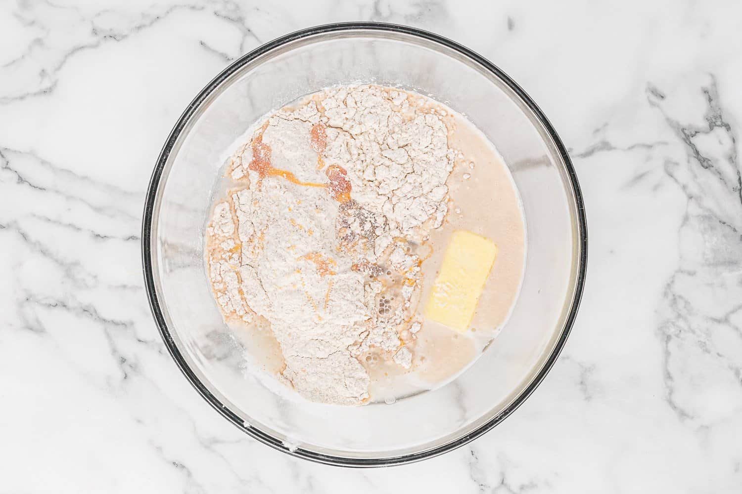 Butter and half of dry ingredients added to bowl.