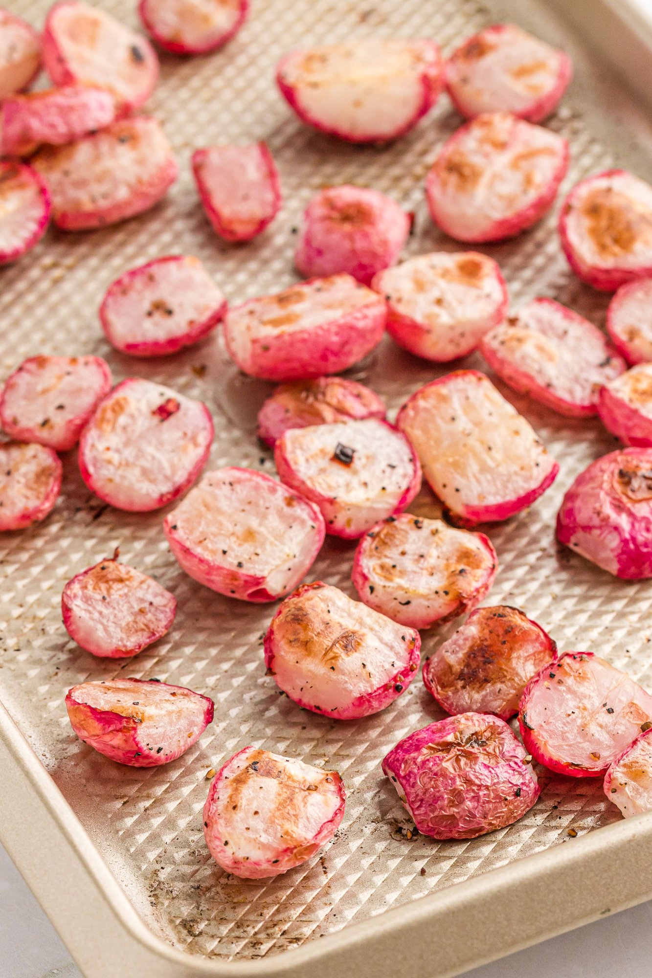 Roasted radishes on a sheet pan.