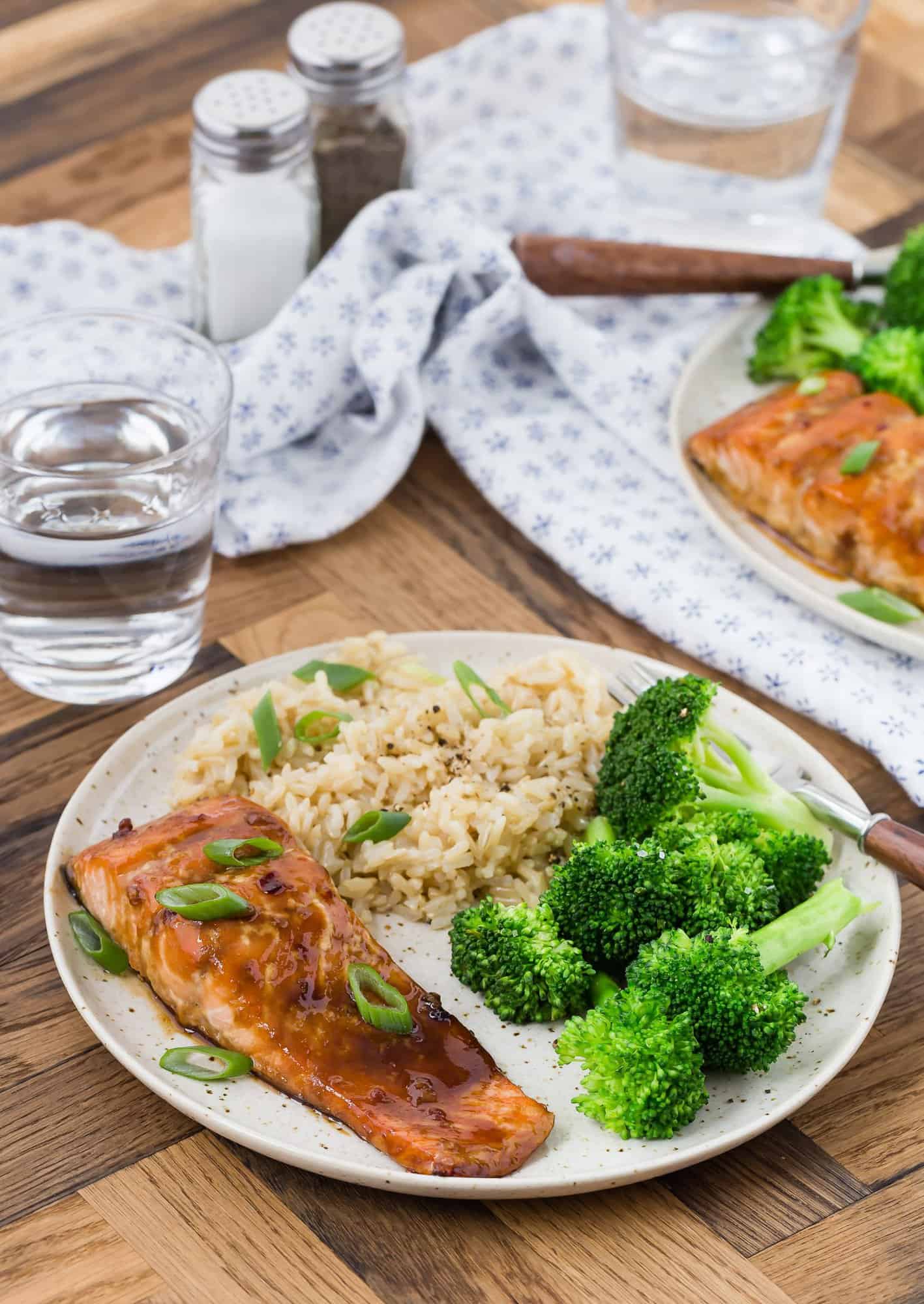 Salmon glazed with honey and soy on a plate with broccoli and rice.