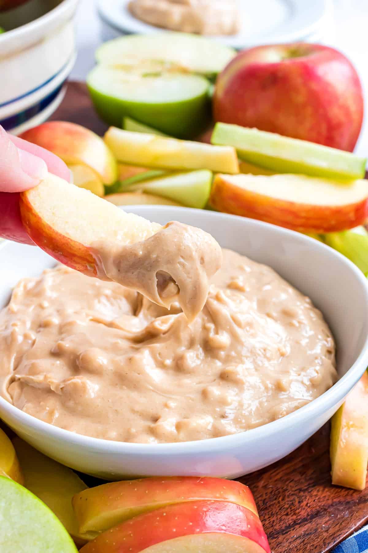 Apple dip with peanut butter, on an apple slice.