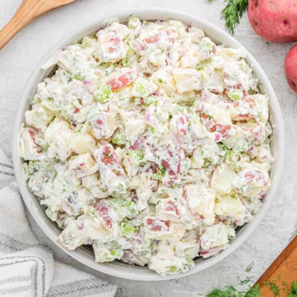 Dill potato salad in a round white bowl.