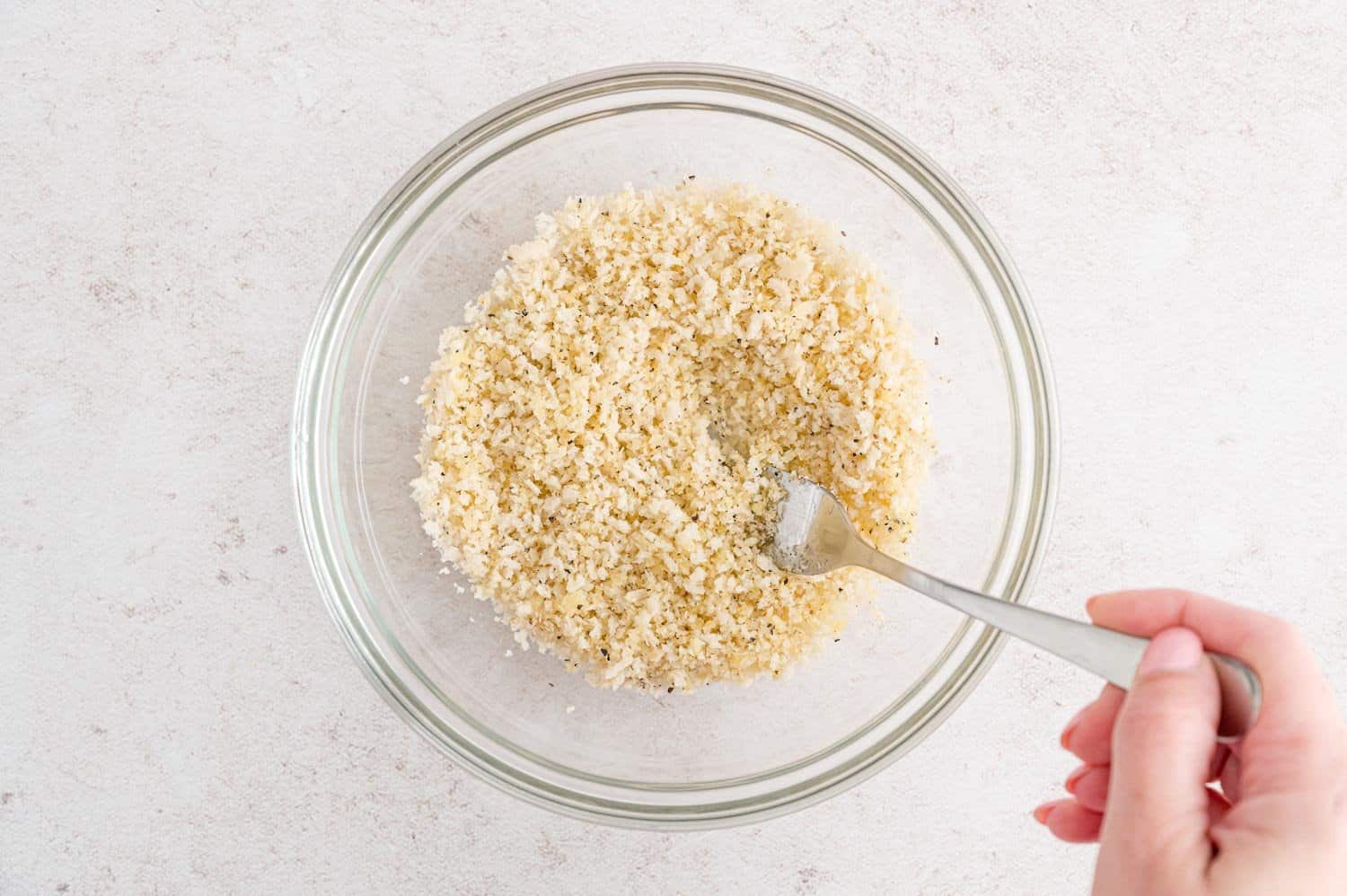 Panko in a bowl being mixed.