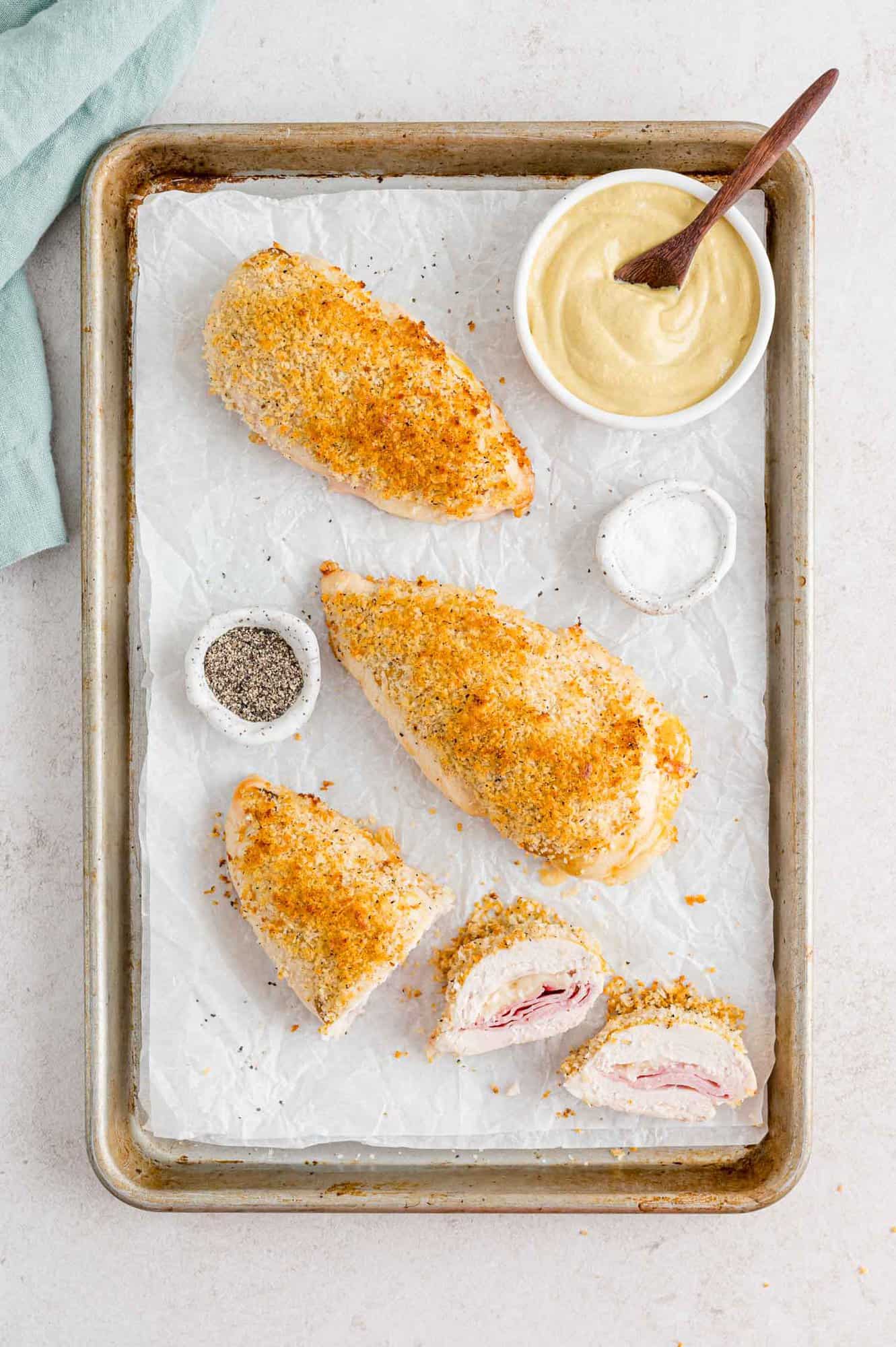 Baked chicken cordon bleu on a sheet pan.