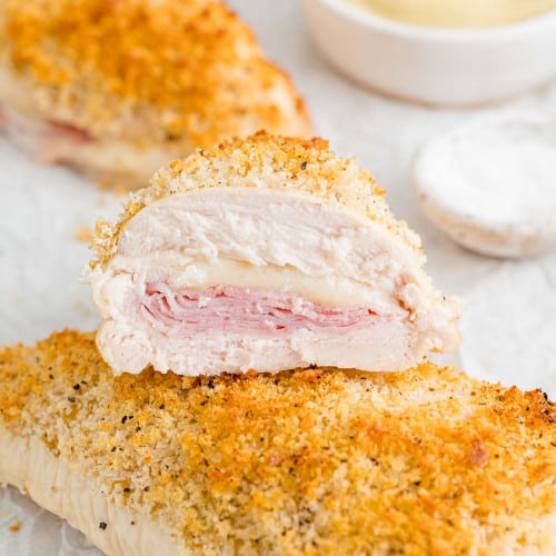 Baked chicken cordon bleu, cut in half to show filling.