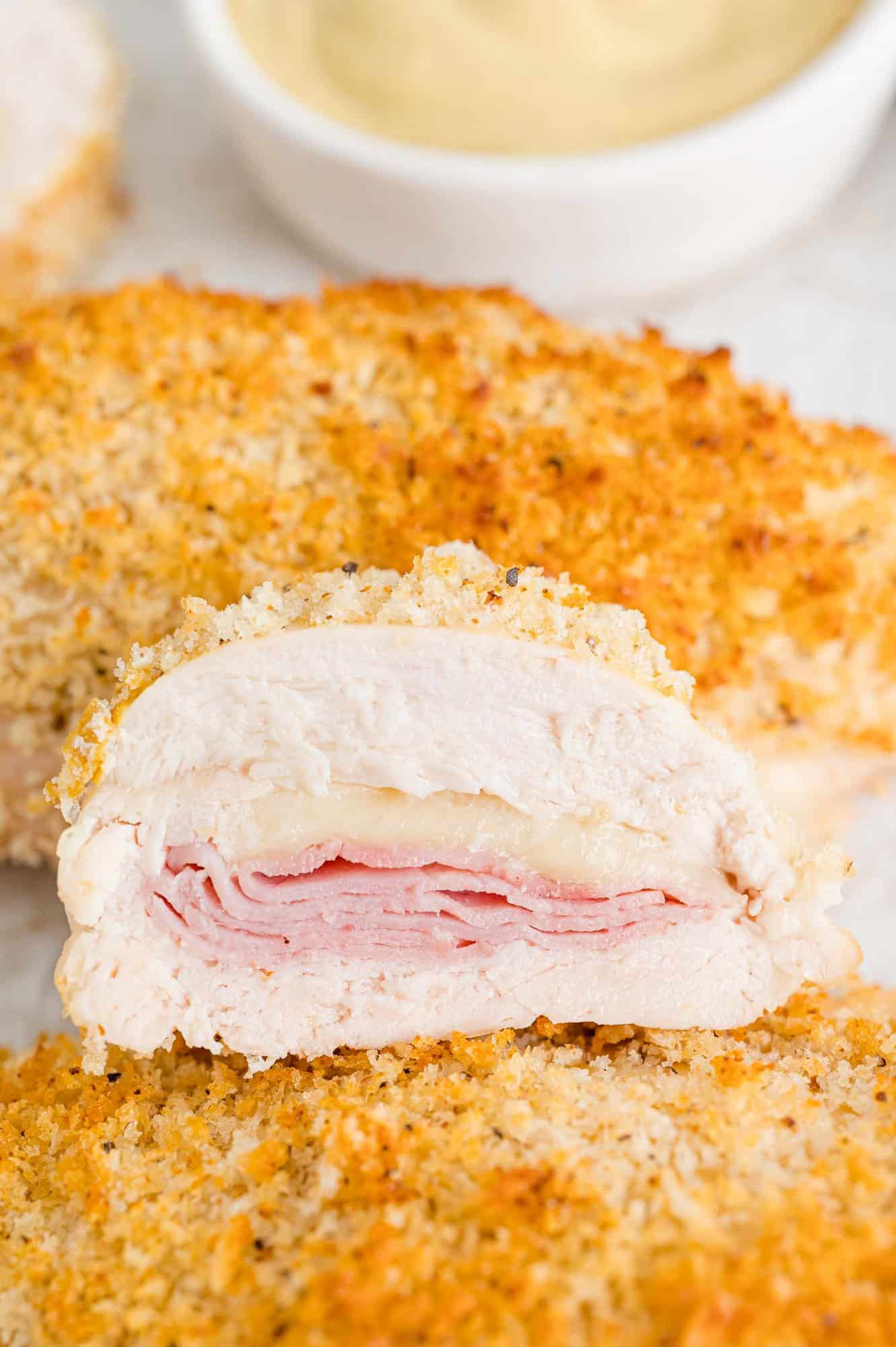 Baked chicken cordon bleu, cut in half to show filling.