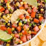 Black bean corn salsa in a bowl with a chip.