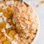 Carrot cake oatmeal with raisins and coconut on top.