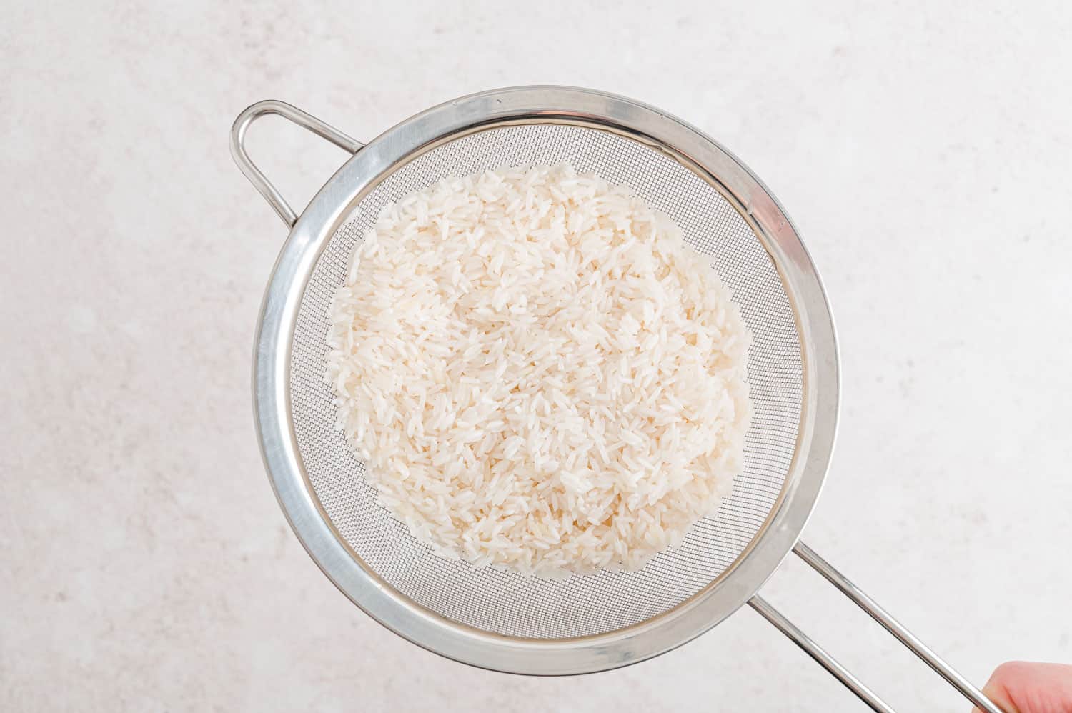 Rice in a strainer.