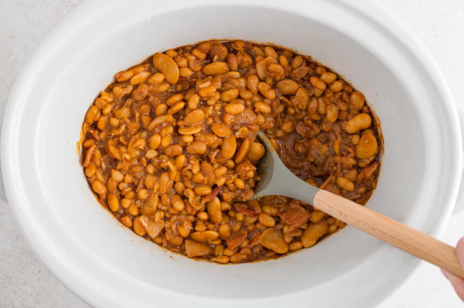 Cooked baked beans in a crock pot.