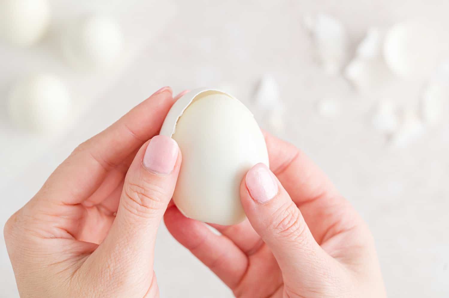 Hard boiled egg being peeled.