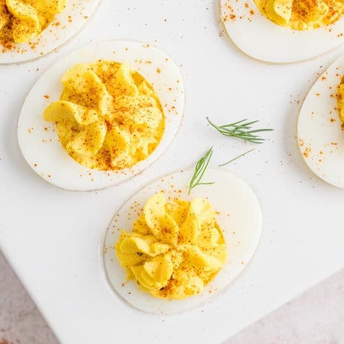 Deviled eggs garnished with paprika.