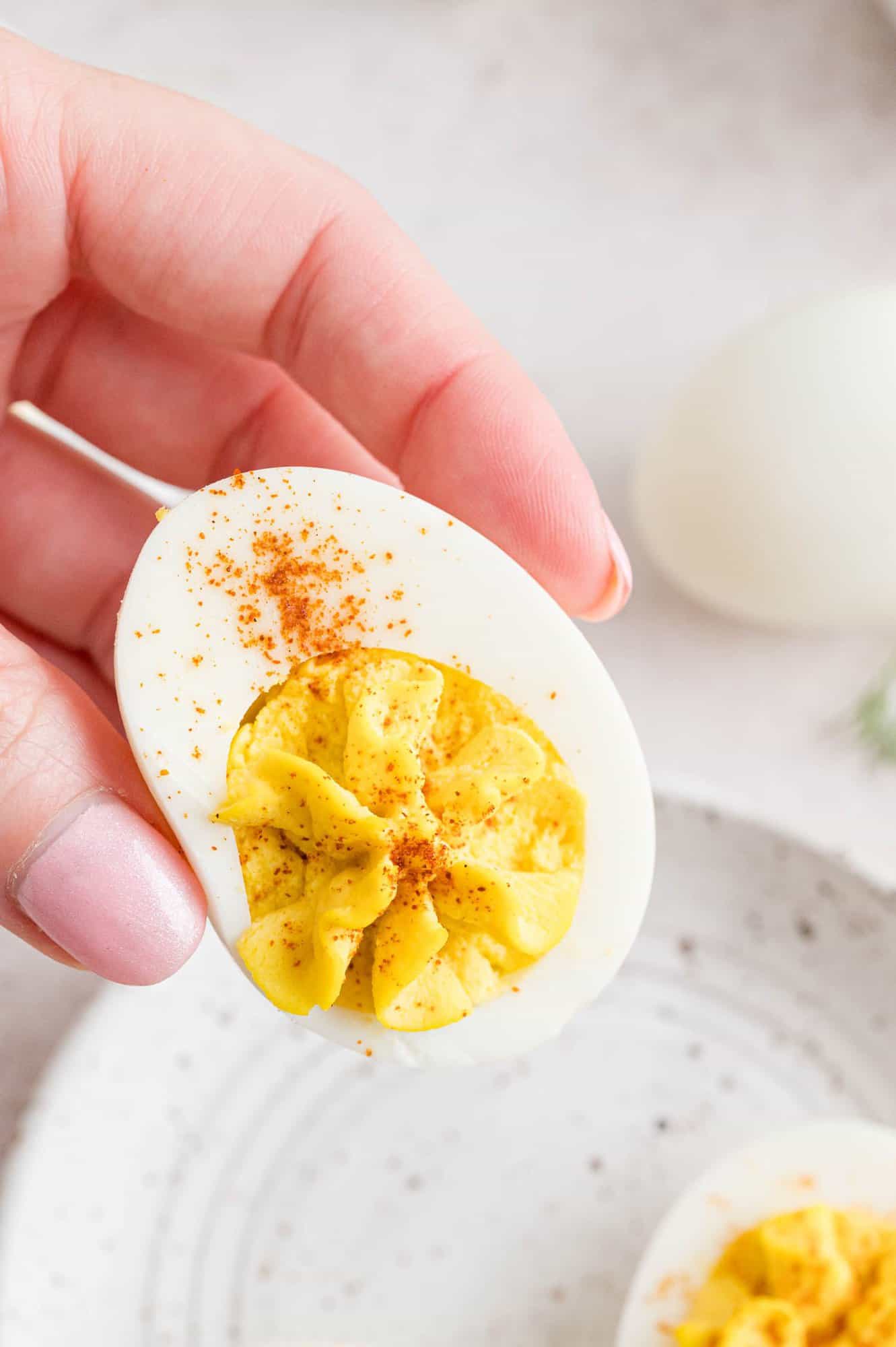 Deviled egg held in a hand.