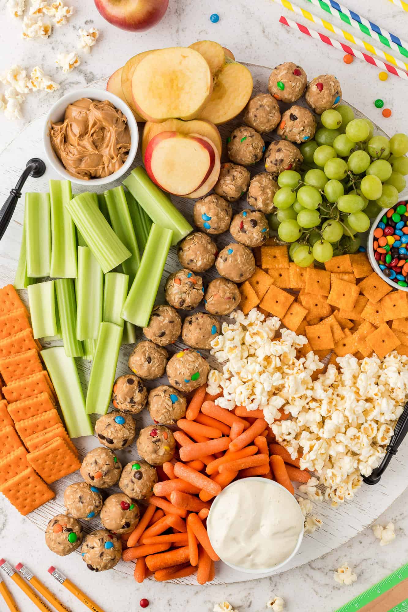 Snack board with fruit, crackers, and more.