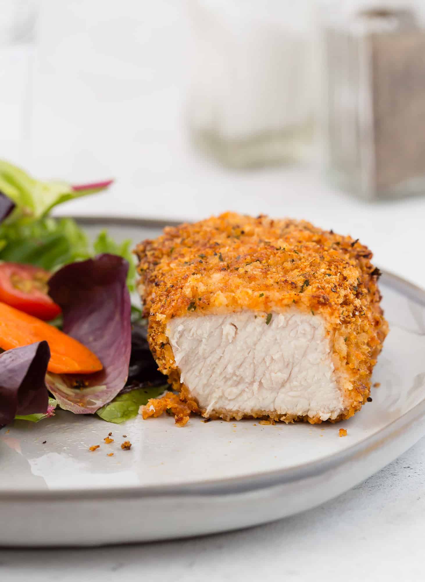 Air fryer breaded pork chop, cut to show inside.