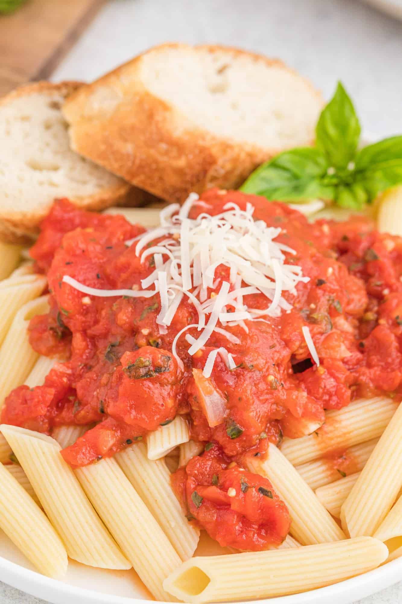 Plate of pasta with arrabbiatea sauce and parmesan.