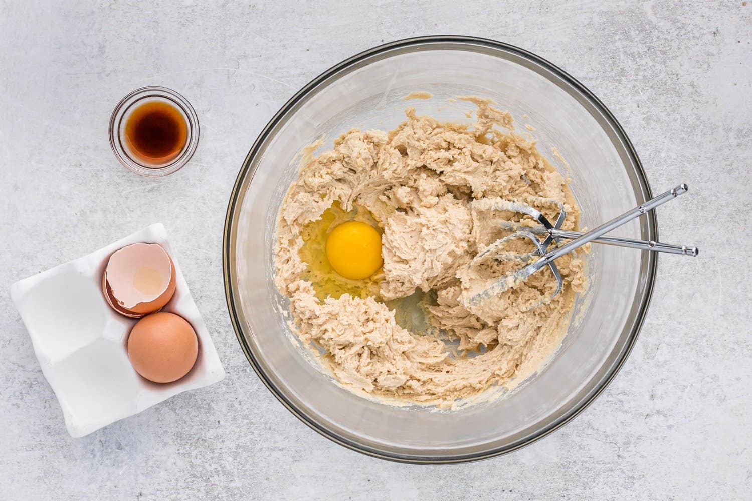 Egg added to butter and sugar mixture.