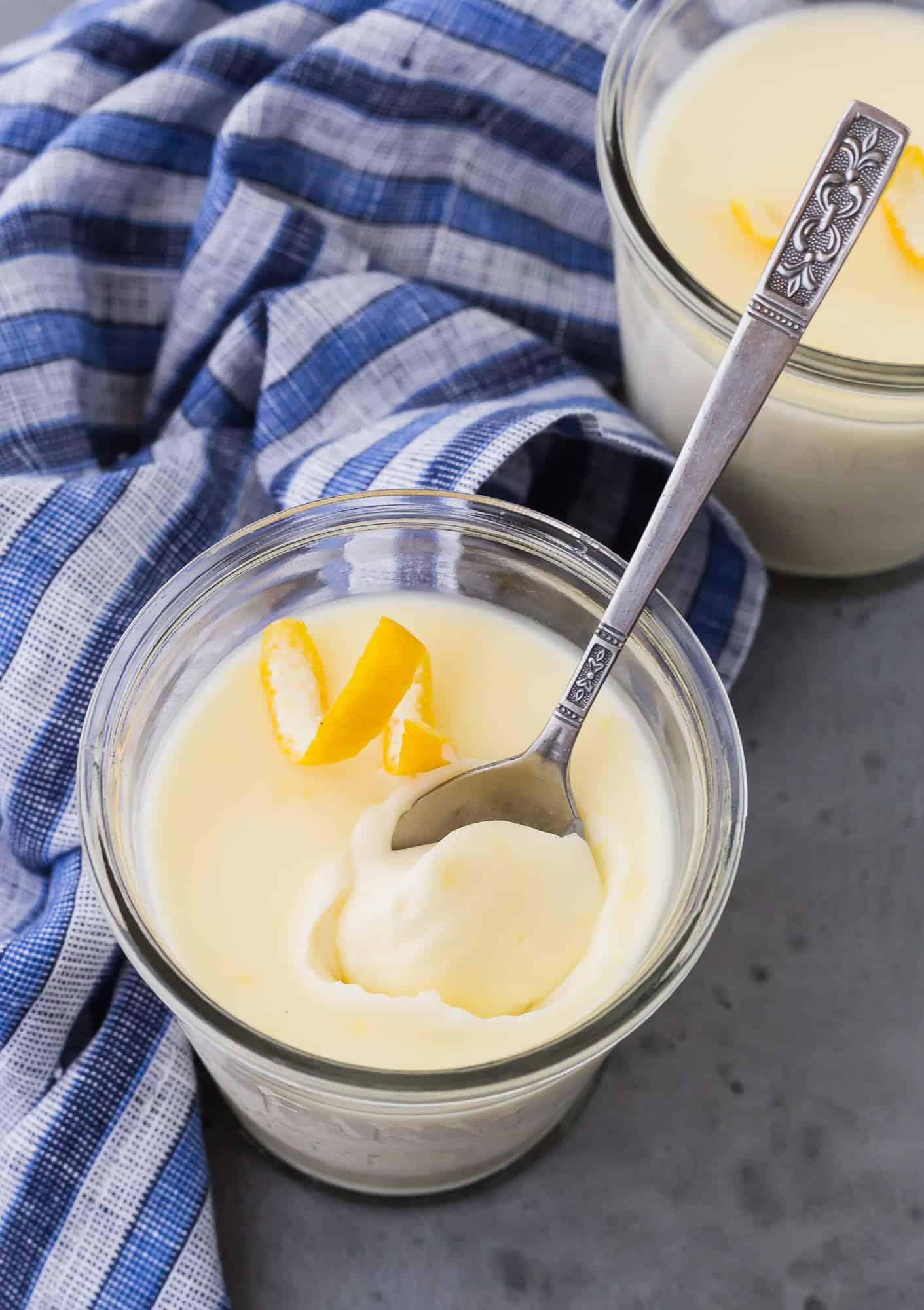 Lemon flavor pudding with a spoon inserted.