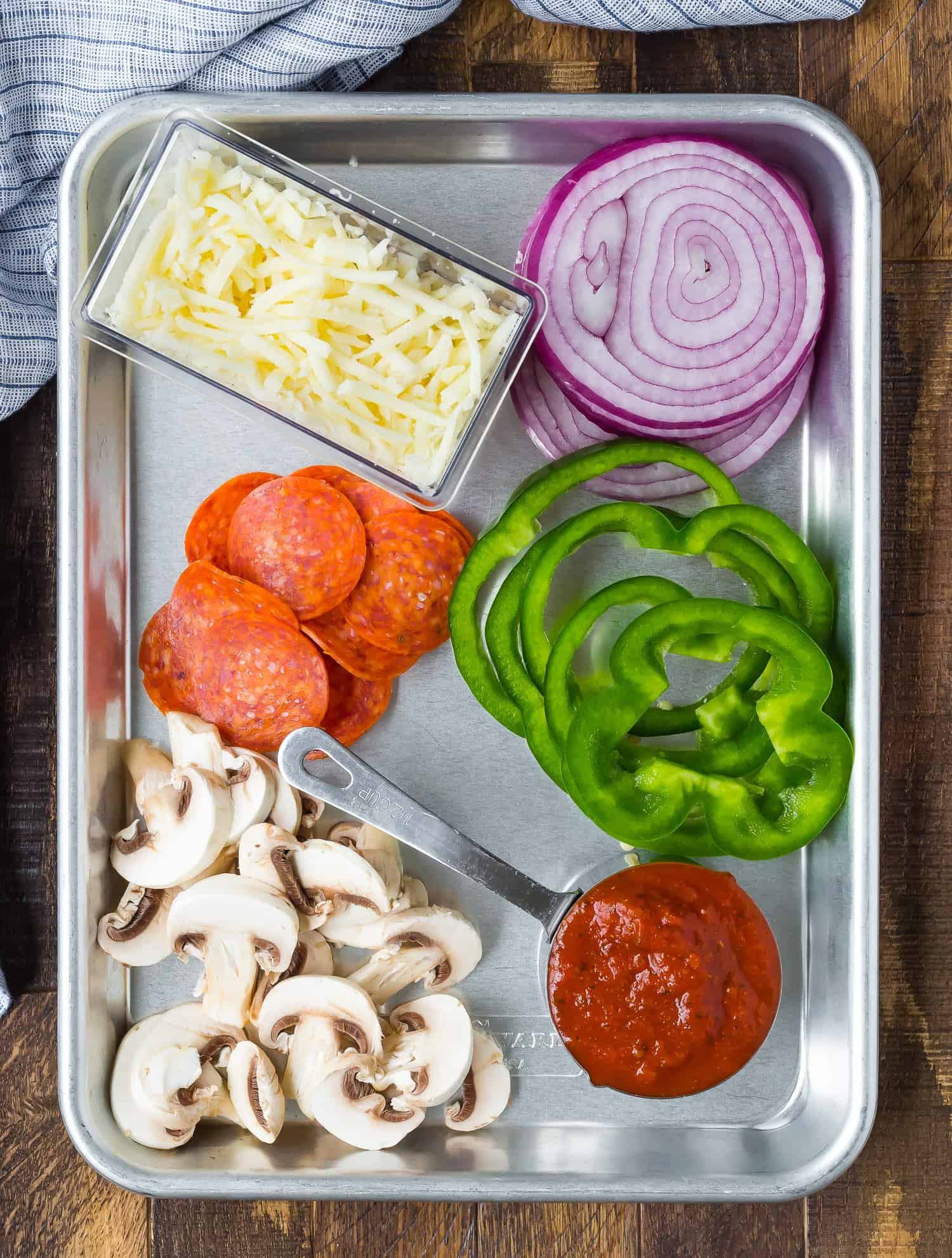 Pizza toppings on a sheet pan.