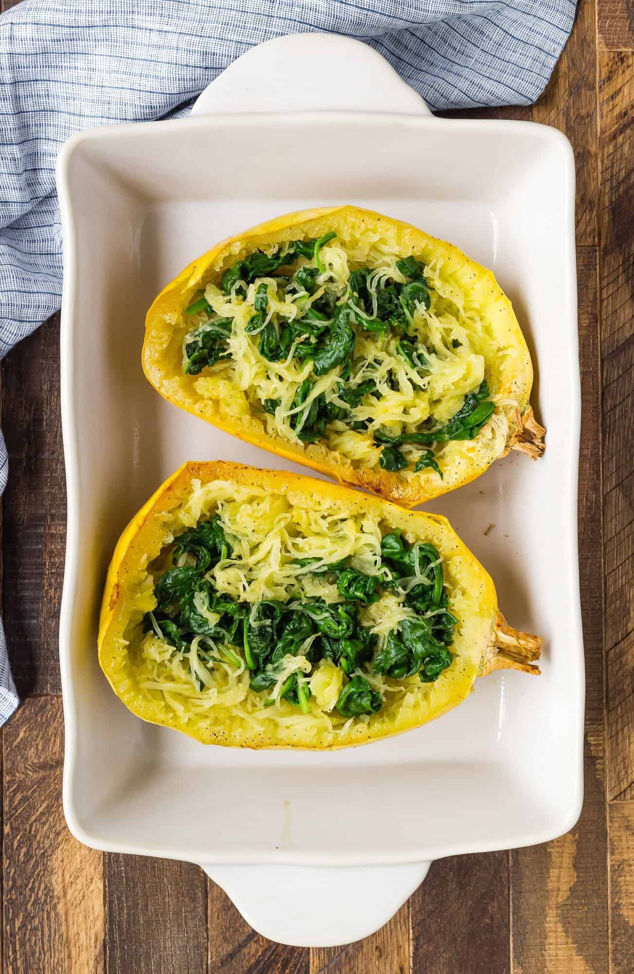 Spinach in cooked spaghetti squash halves.