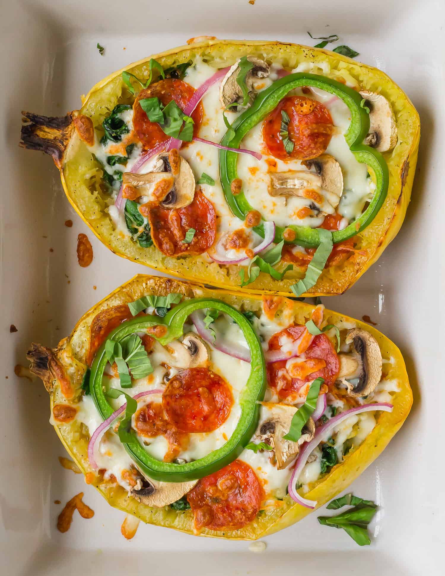 Pizza stuffed spaghetti squash with cheese, pepperoni, and vegetables.