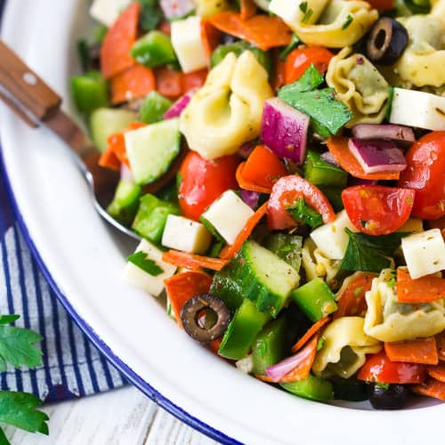 Tortellini pasta salad with pepperoni, olives, onion, cucumber, and more.