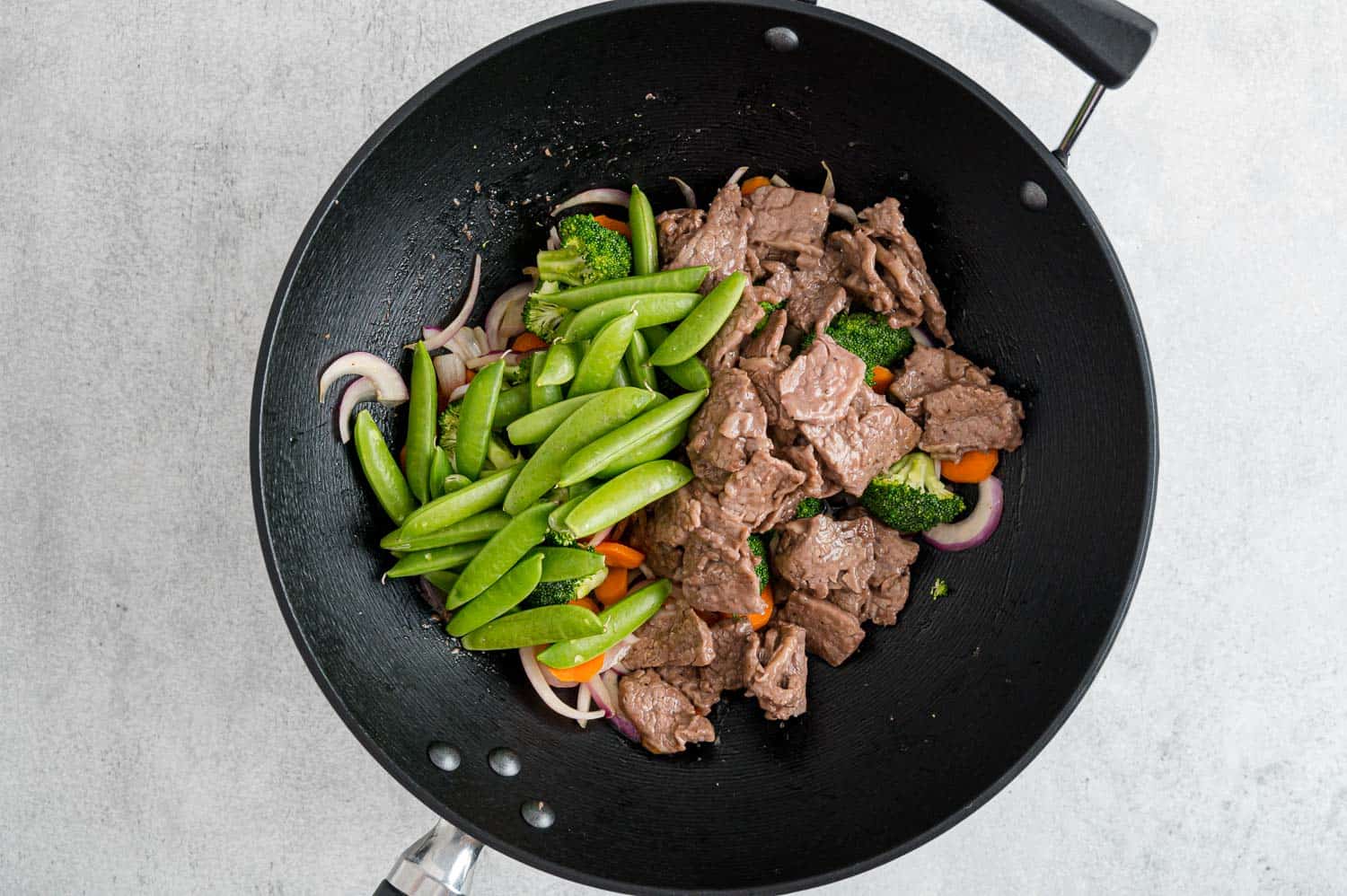 Beef and peas added to pan.