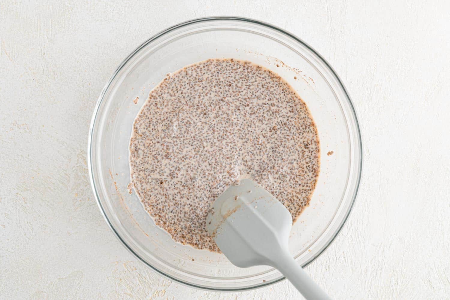 Chia pudding being stirred.