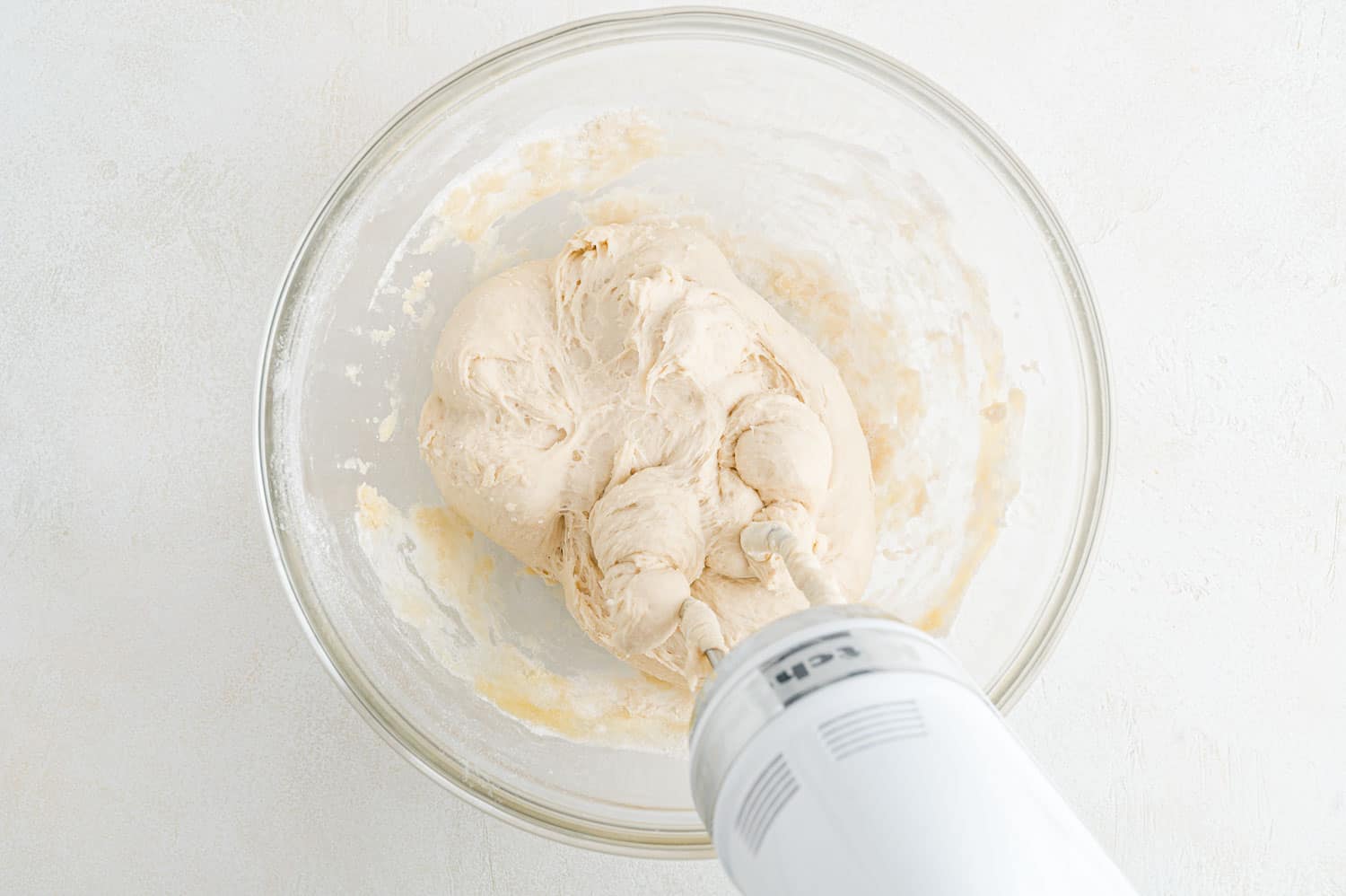 Dough pulling away from edges of bowl.