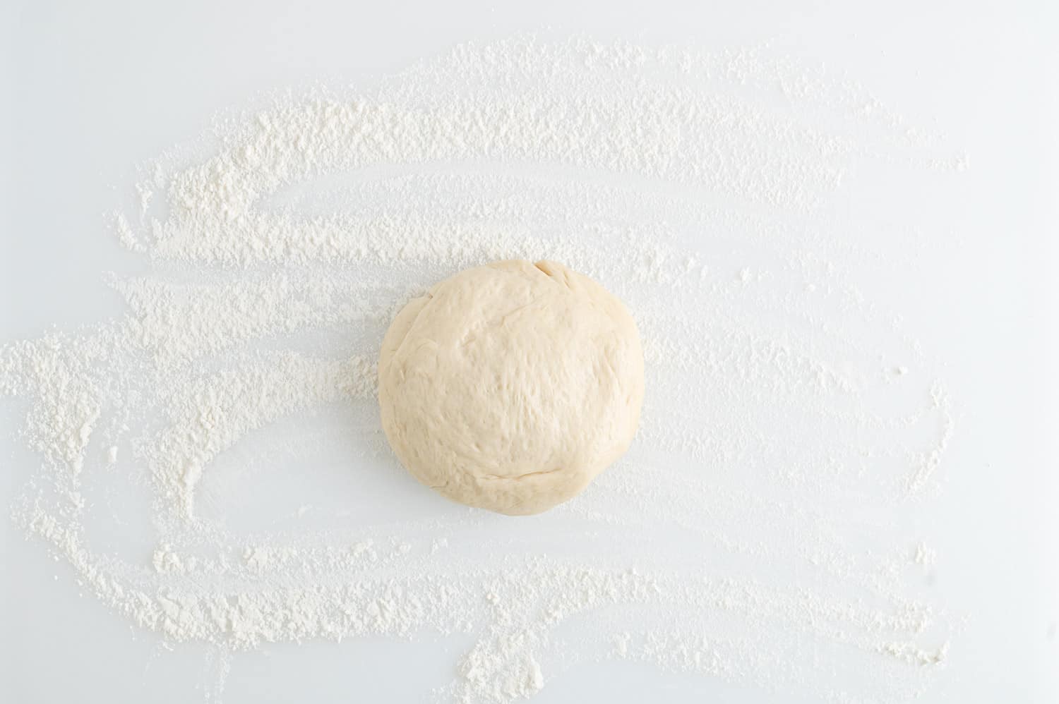 Dough ball on floured surface.